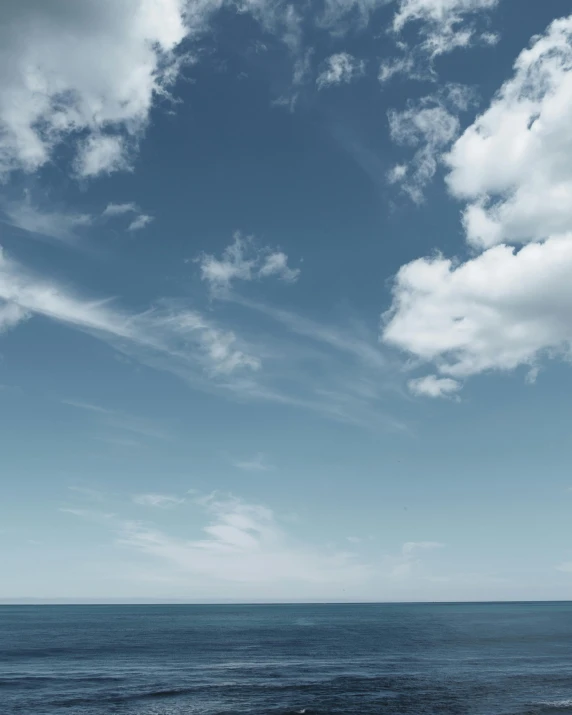 a man riding a surfboard on top of a sandy beach, unsplash, minimalism, tall fluffy clouds, standing on a cloud, sky whales, sitting in a fluffy cloud