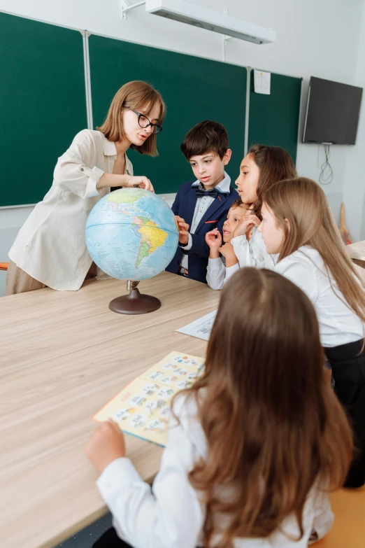 a teacher teaching children how to use a globe, a picture, by Adam Marczyński, pexels contest winner, danube school, mini model, 15081959 21121991 01012000 4k, product introduction photo, middle centered