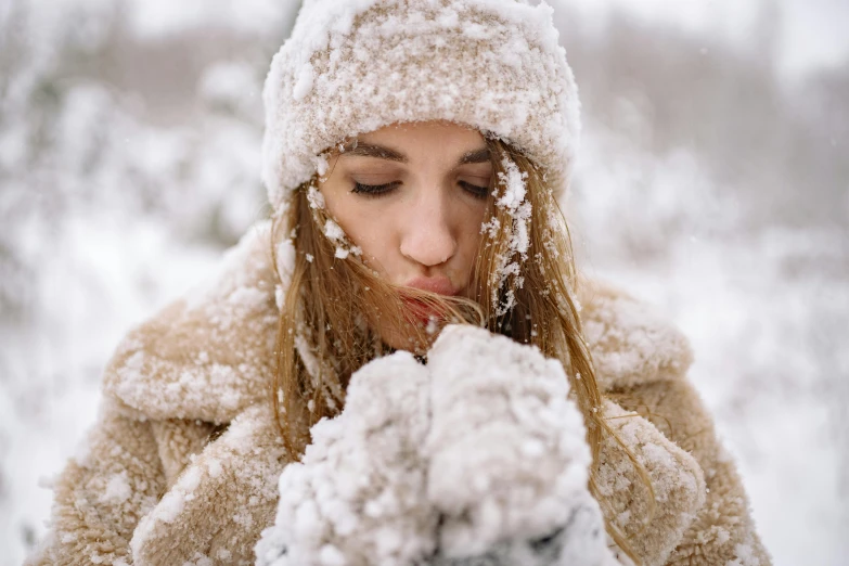 a woman is blowing snow on her face, trending on pexels, renaissance, cuddly, tan, white, thumbnail