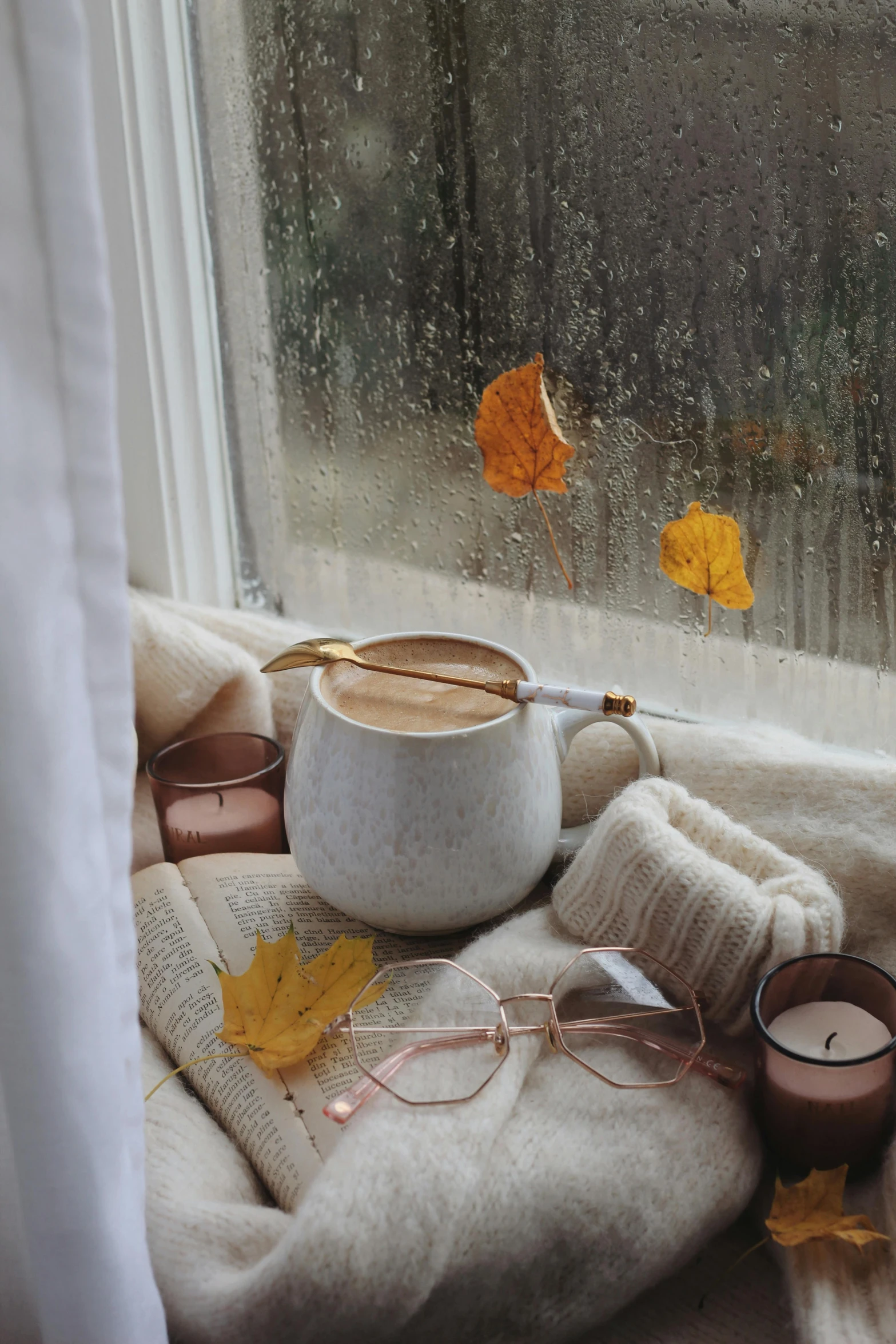 a cup of coffee sitting on top of a window sill, a picture, inspired by Elsa Bleda, trending on pexels, aestheticism, 🍂 cute, with square glasses, maple syrup highlights, ivory and copper