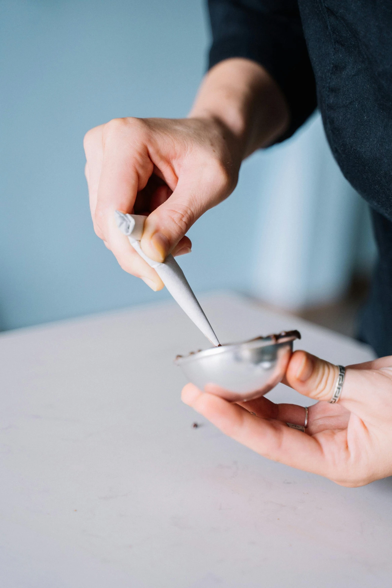 a close up of a person holding a spoon, by Nina Hamnett, unsplash, process art, silver egg cup, superres sharpening, oysters, carefully crafted
