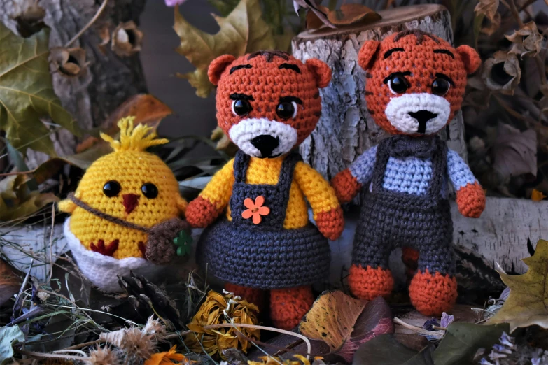 a couple of stuffed animals standing next to each other, by Maksimilijan Vanka, crochet, in the autumn forest, tony the tiger, tiny villagers