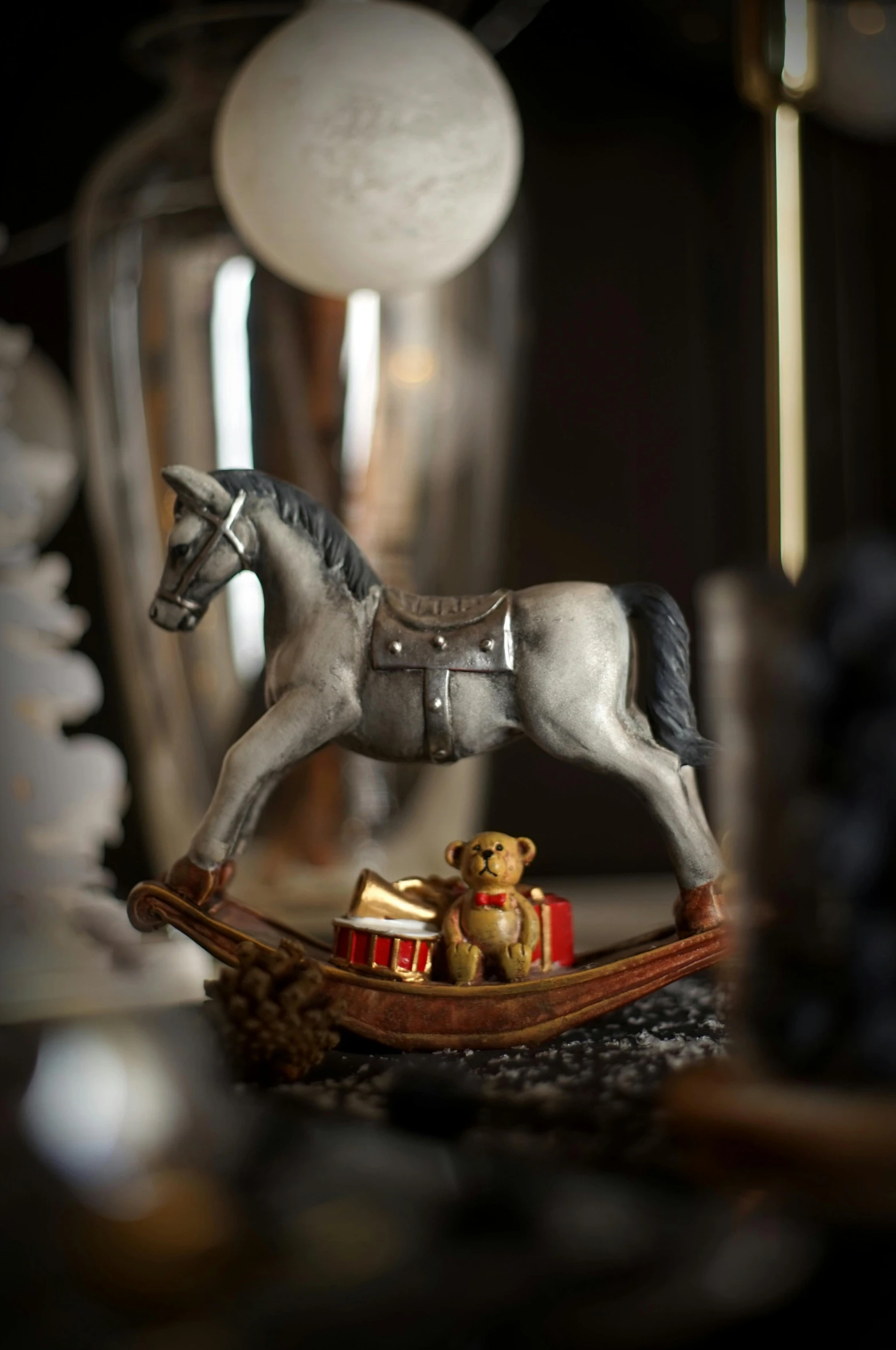 a close up of a toy horse on a table, a statue, inspired by Rudolph F. Ingerle, grey and silver, santa, slide show, small