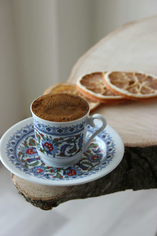 a cup of coffee sitting on top of a saucer, inspired by Fikret Muallâ Saygı, arabesque, “ iron bark, toast, terracotta, food