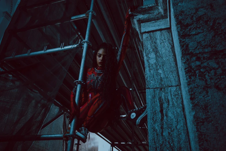 a woman standing on top of a scaffolding next to a building, inspired by Elsa Bleda, pexels contest winner, ariana grande as a sith, red mechanical body, techwear clothes, sitting on the ground