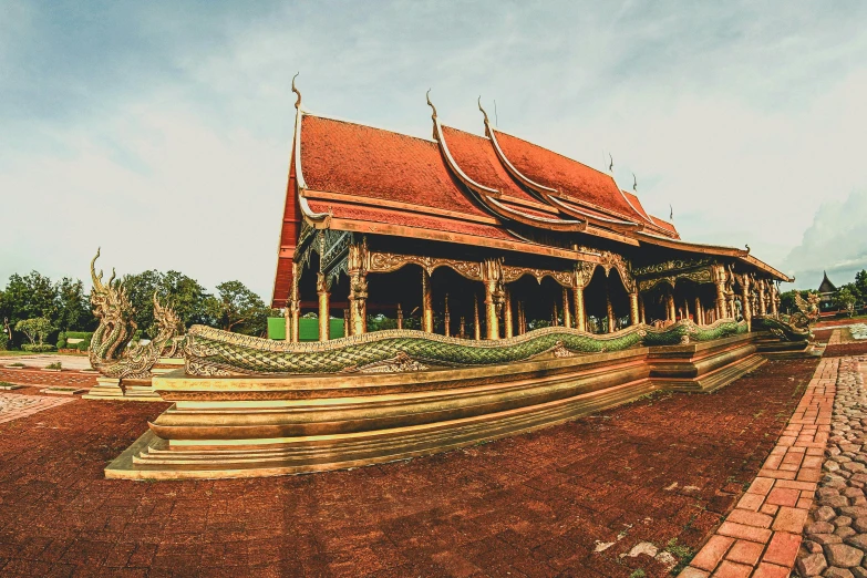a large building sitting on top of a dirt field, pexels contest winner, thai temple, intricate copper details, square, postprocessed)