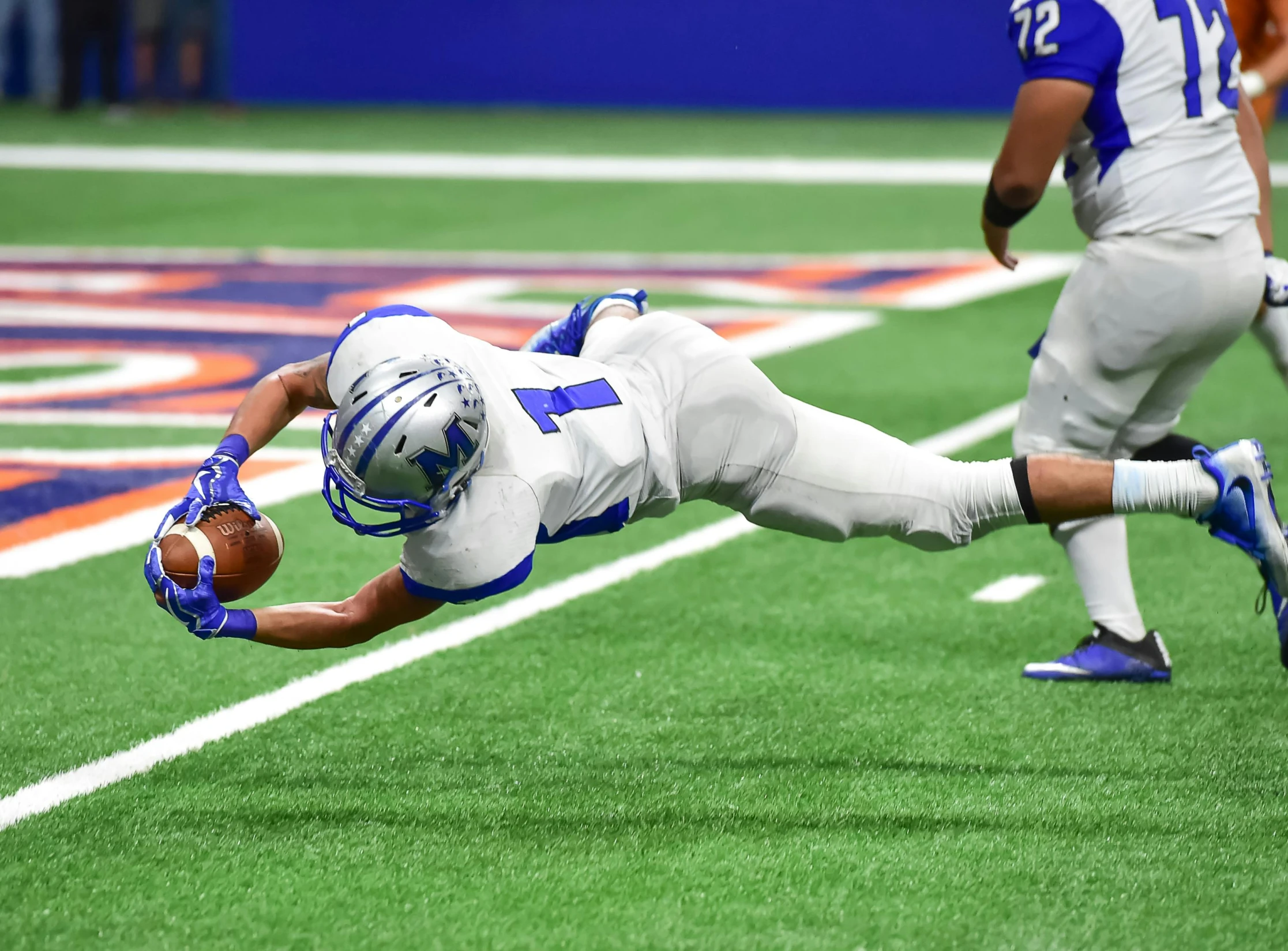 a football player dives to catch a ball, a digital rendering, pexels contest winner, shot on sony a 7, gif, 🇺🇦, laying down