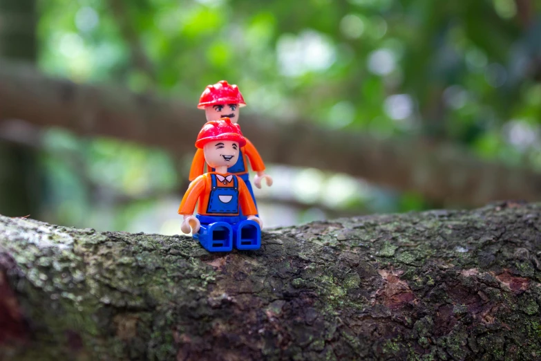 a lego man sitting on top of a tree branch, a picture, inspired by Lydia Field Emmet, unsplash, little elf girl, forest picnic, blippi, female explorer mini cute girl