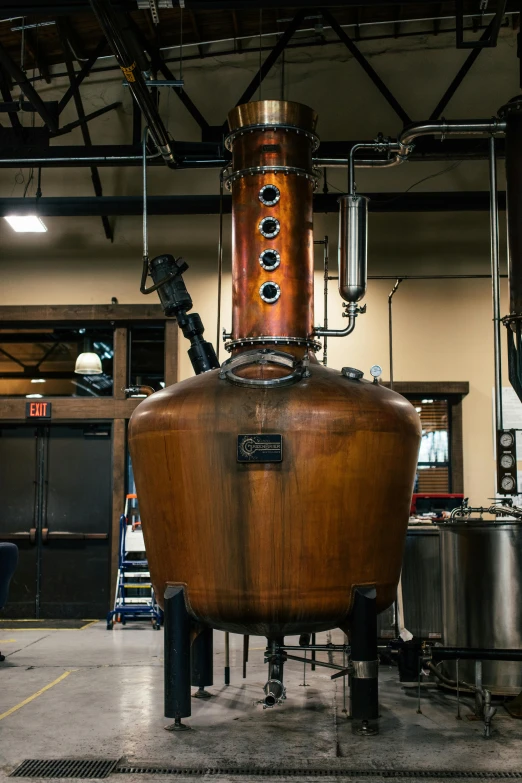 a large copper pot sitting inside of a building, whiskey, long neck, vapor, full room view