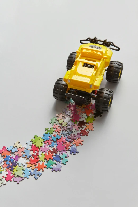 a toy truck sitting on top of a pile of puzzle pieces, a jigsaw puzzle, by Jessie Algie, 2 5 6 colors, off - road, wide overhead shot, transforming