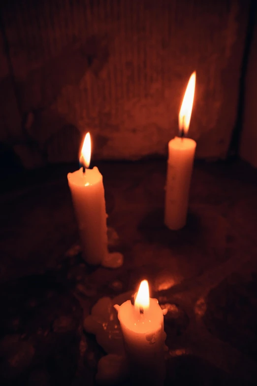 a couple of candles sitting on top of a table, inside a tomb, profile image
