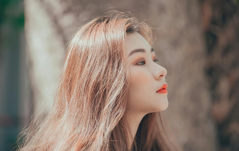 a woman with long hair standing in front of a tree, inspired by Huang Ji, trending on pexels, smoothed lip line, her skin is light brown, coral lipstick, korean woman