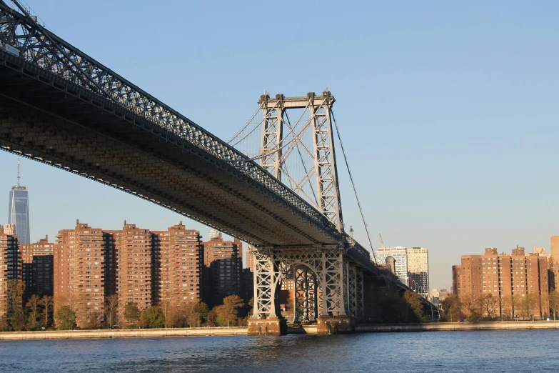 a bridge over a body of water with a city in the background, by Edward Avedisian, unsplash, harlem, le corbusier, slide show, high bridges