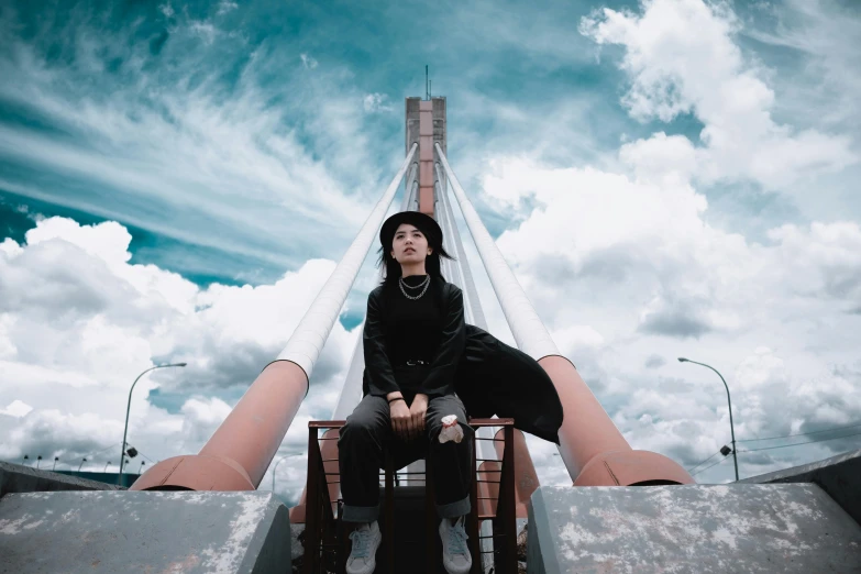 a man sitting on top of a skateboard ramp, by Emma Andijewska, pexels contest winner, surrealism, girl clouds, standing on the mast, cai xukun, looking up at camera