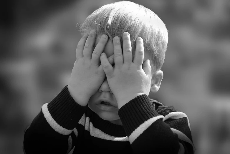 a young boy covering his eyes with his hands, a picture, by Jan Rustem, pixabay, bw photo, frustrated, blond boy, toddler