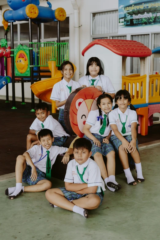 a group of young children posing for a picture, inspired by Ni Yuanlu, pexels contest winner, danube school, softplay, uniform background, high angle shot, private academy entrance