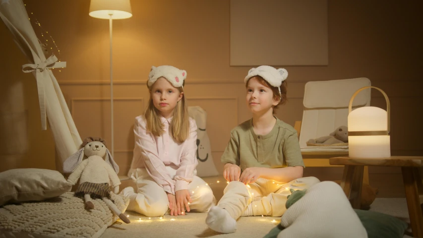 a couple of kids sitting on top of a bed, inspired by Elsa Beskow, pexels, magical realism, soft lighting 8 k resolution, with rap cap on head, firefly lights, live action children's tv show