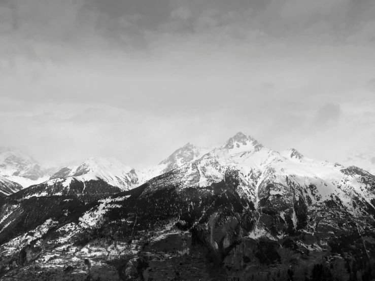 a black and white photo of a mountain range, a black and white photo, by Cedric Peyravernay, unsplash, 4k. high quality, portrait of tall, winter photograph, various posed