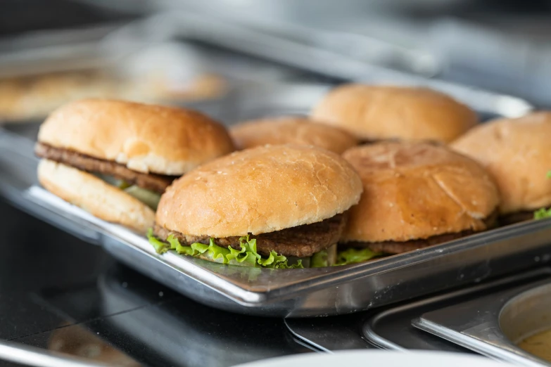 a tray of hamburgers sitting on top of a table, profile image, bao phan, high quality product image”