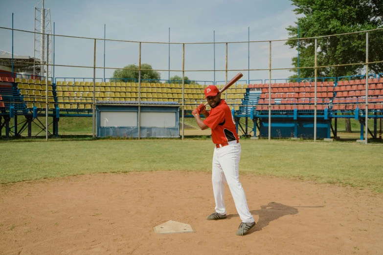 a man holding a baseball bat on top of a field, practice, colombian, full body image, high quality picture