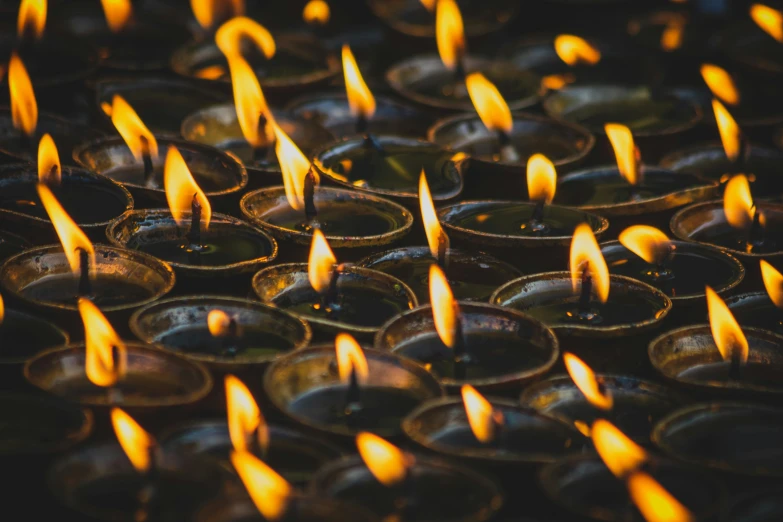 many lit candles are lined up in rows, trending on unsplash, thangka, fan favorite, instagram post, nepal