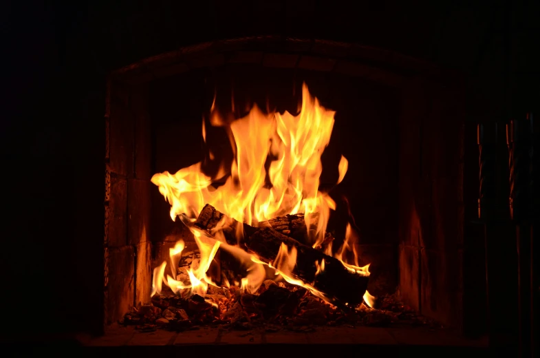 a close up of a fire in a fireplace, by John Murdoch, features