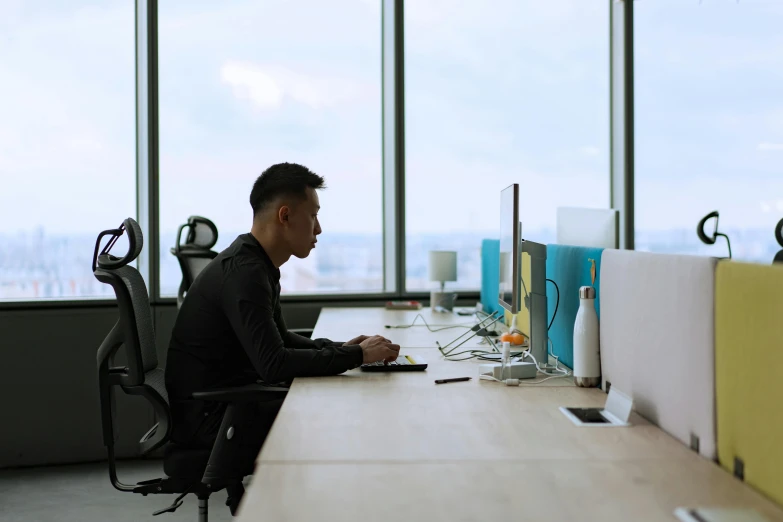 a man sitting at a desk working on a computer, pexels contest winner, sitting alone, asian male, no text, avatar image