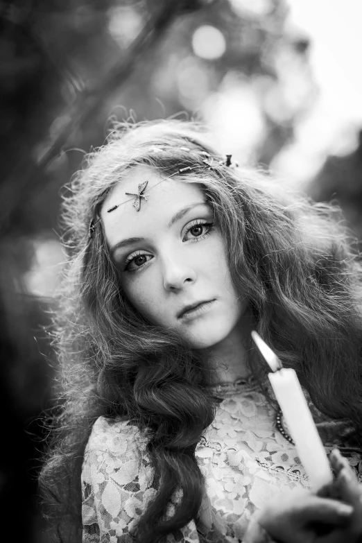 a black and white photo of a woman holding a candle, inspired by irakli nadar, renaissance, fae teenage girl, amy yasbeck, young beautiful hippie girl, with a straw