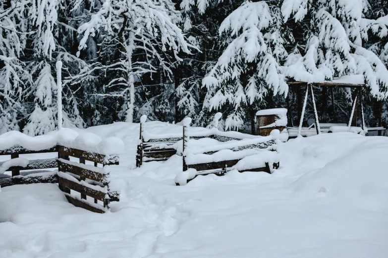 a wooden bench sitting in the middle of a snow covered forest, pexels contest winner, white picket fence, wooden structures, background image, piled around