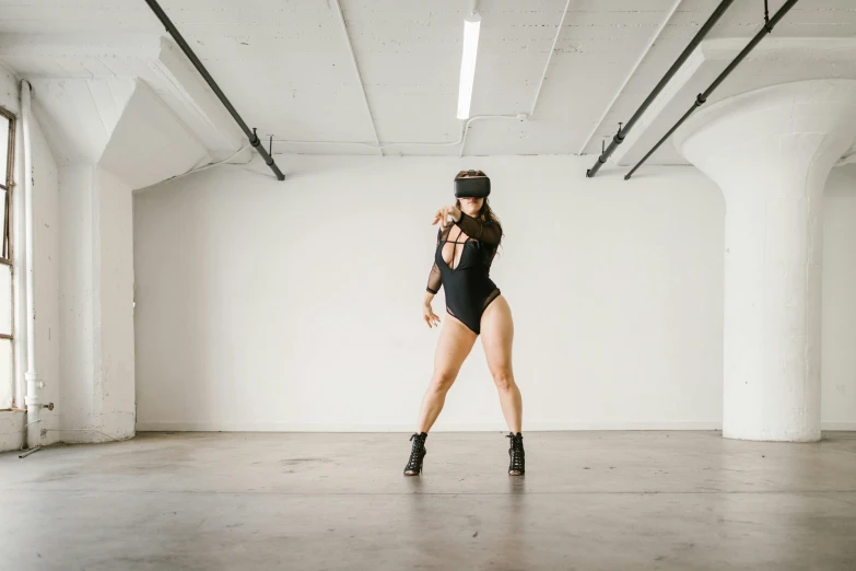a woman in a black bodysuit posing for a picture, unsplash, video art, wrestlers wearing vr headsets, thighs focus, in empty space, blindfolded