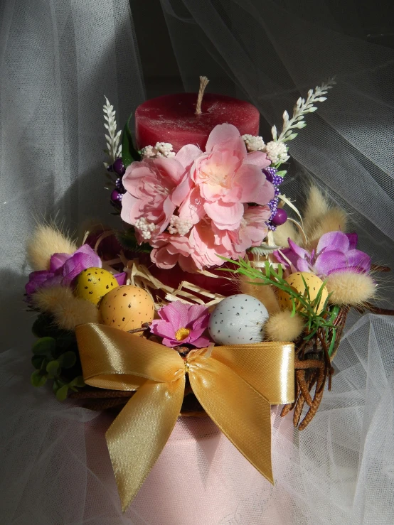 a basket filled with eggs and flowers on top of a table, on a candle holder, 王琛, crimson themed, frontal shot
