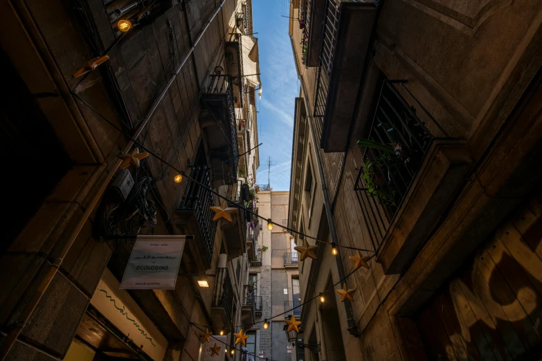 a narrow street filled with lots of tall buildings, an album cover, pexels contest winner, barcelona, gas lamps, naples, brown