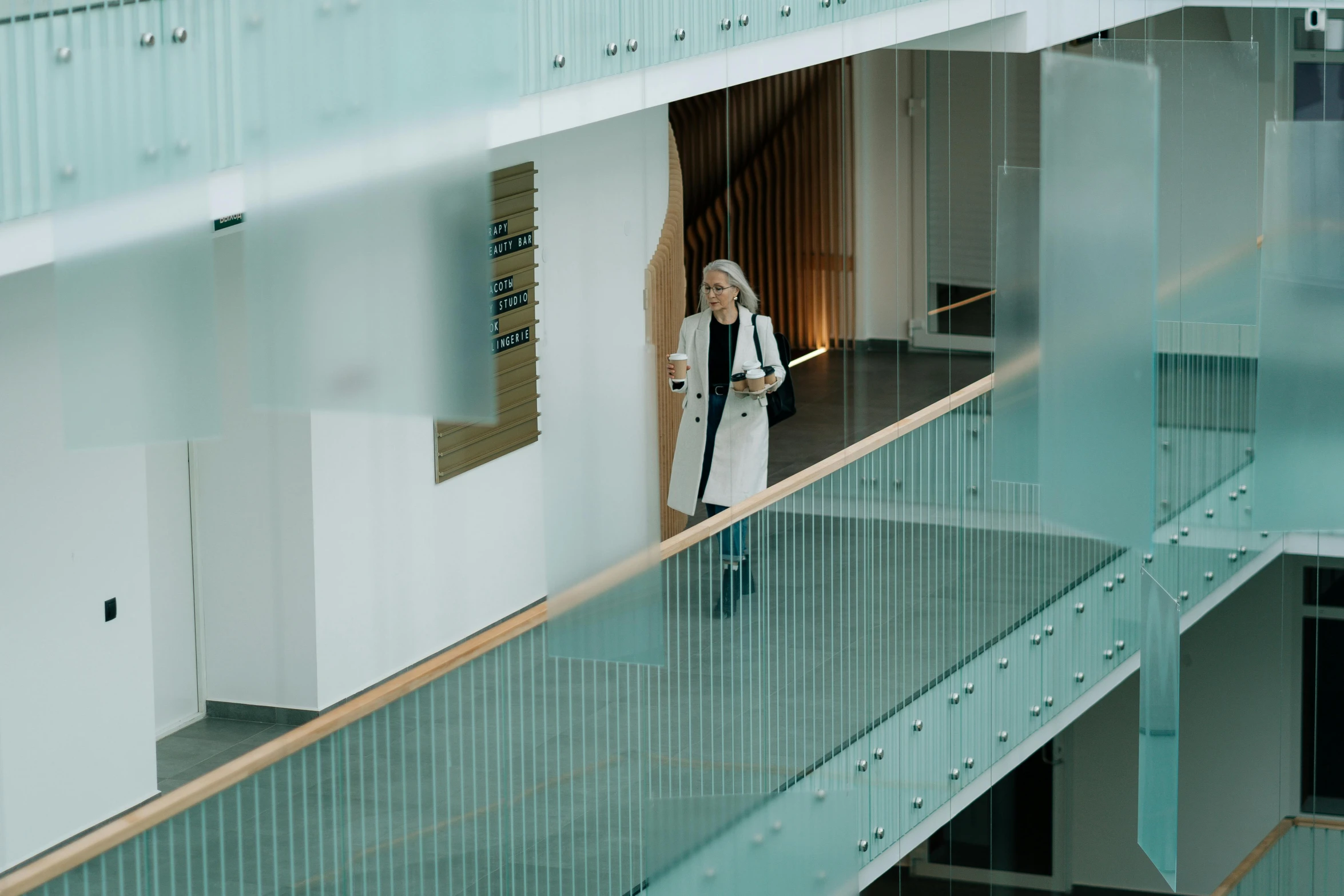 a woman in a white dress standing on a balcony, pexels contest winner, modernism, hospital interior, walking to work, reykjavik junior college, inside a science facility