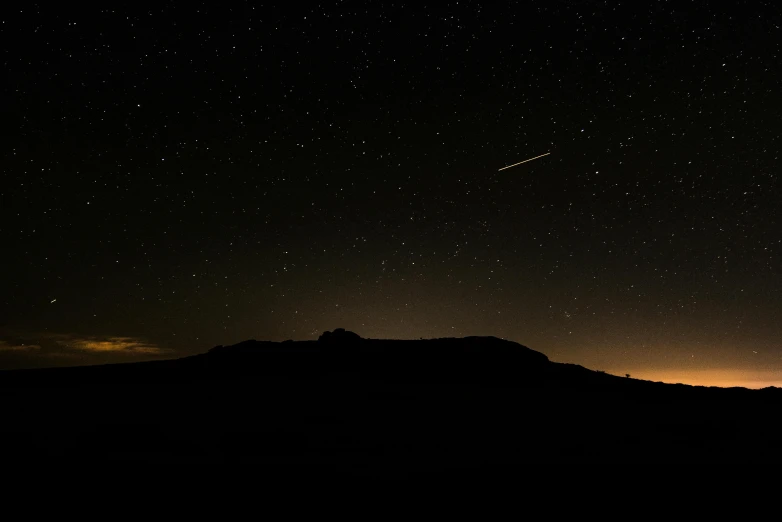 a sky filled with lots of stars next to a mountain, shooting star, sparse dark atmosphere, mars setting, 2022 photograph