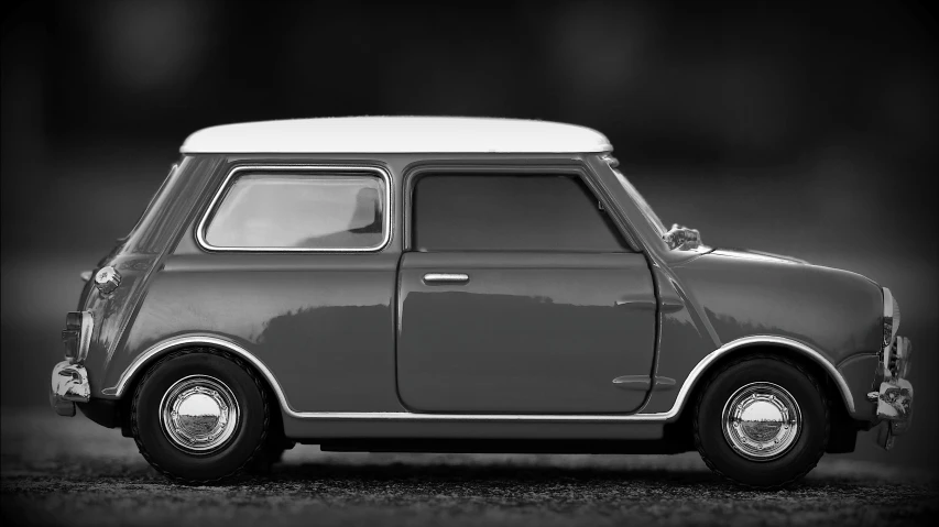 a black and white photo of a small car, by Gavin Nolan, unsplash, photorealism, mini model, 6 0 s style, 3ds max render, lit from the side