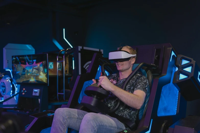 a man sitting in a chair playing a video game, a hologram, unsplash, interactive art, alien racing drivers, a busy arcade, 3 d goggles, avatar image