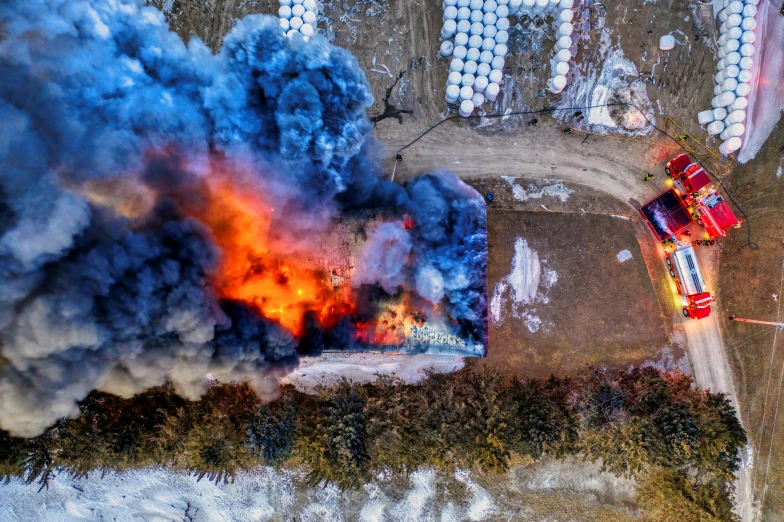 an aerial view of a fire in a field, pexels contest winner, charge explosives, fire and ice, smoke filled room, nanquan