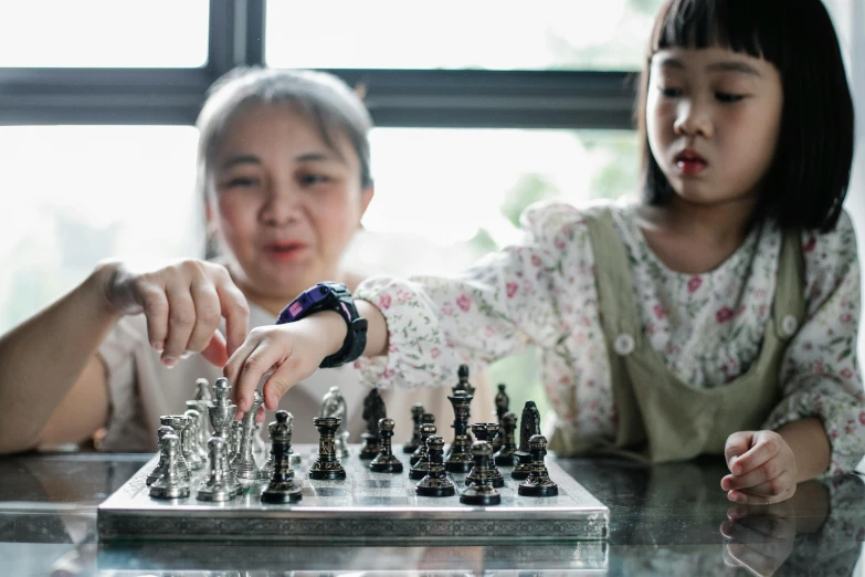 a woman and a child playing a game of chess, pexels contest winner, interactive art, huang yuxing and aya takano, thumbnail, full frame image