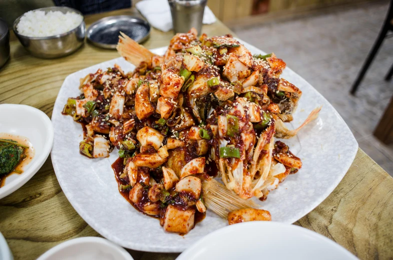 a close up of a plate of food on a table, by Meredith Dillman, unsplash, mingei, hong soonsang, square, multiple arms, chitin