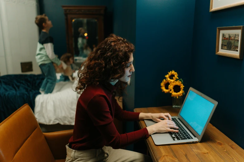 a woman sitting at a desk using a laptop computer, by Julia Pishtar, trending on pexels, someone sits in bed, lachlan bailey, leesha hannigan, profile image