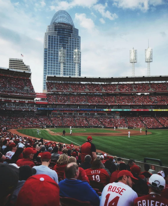 a crowd of people watching a baseball game, by Carey Morris, pexels contest winner, reds, lgbtq, lots of building, promo image