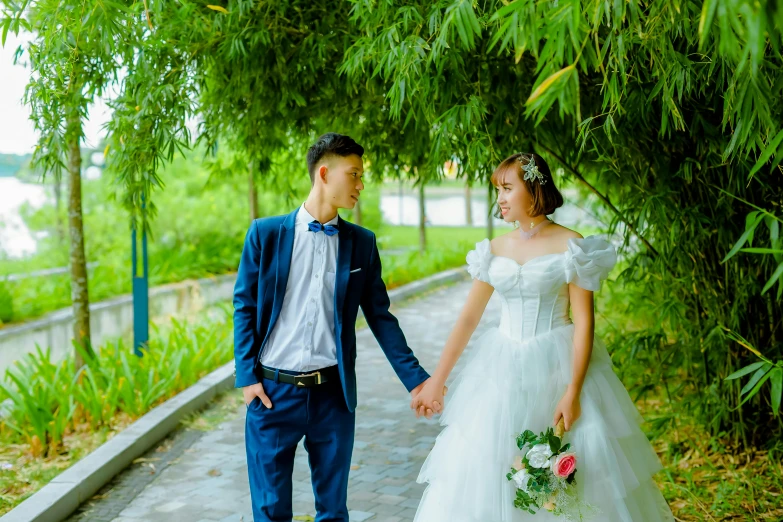 a bride and groom holding hands walking down a path, a colorized photo, unsplash, vietnamese woman, avatar image, attractive photo, youtube thumbnail