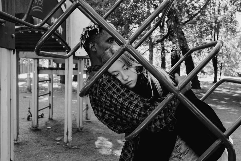 a black and white photo of a girl on a playground, a black and white photo, by Emma Andijewska, pexels, realism, couple kissing, xxxtentacion, playboi carti portrait, he holds her while she sleeps