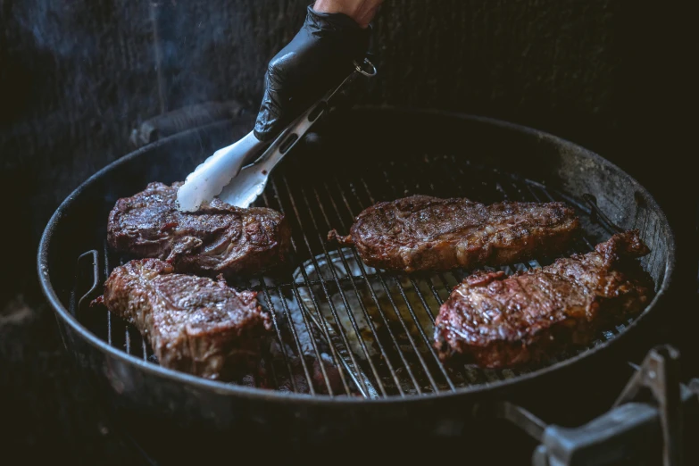 a person cooking steaks on a grill with a spatula, a portrait, by Daniel Lieske, pexels contest winner, 🦩🪐🐞👩🏻🦳, meat veins, rib cage, exterior shot