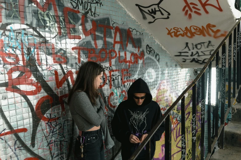 a couple of women standing next to each other, a photo, by Micha Klein, pexels contest winner, graffiti, wearing a black hoodie, avatar image, mezzanine, instagram picture
