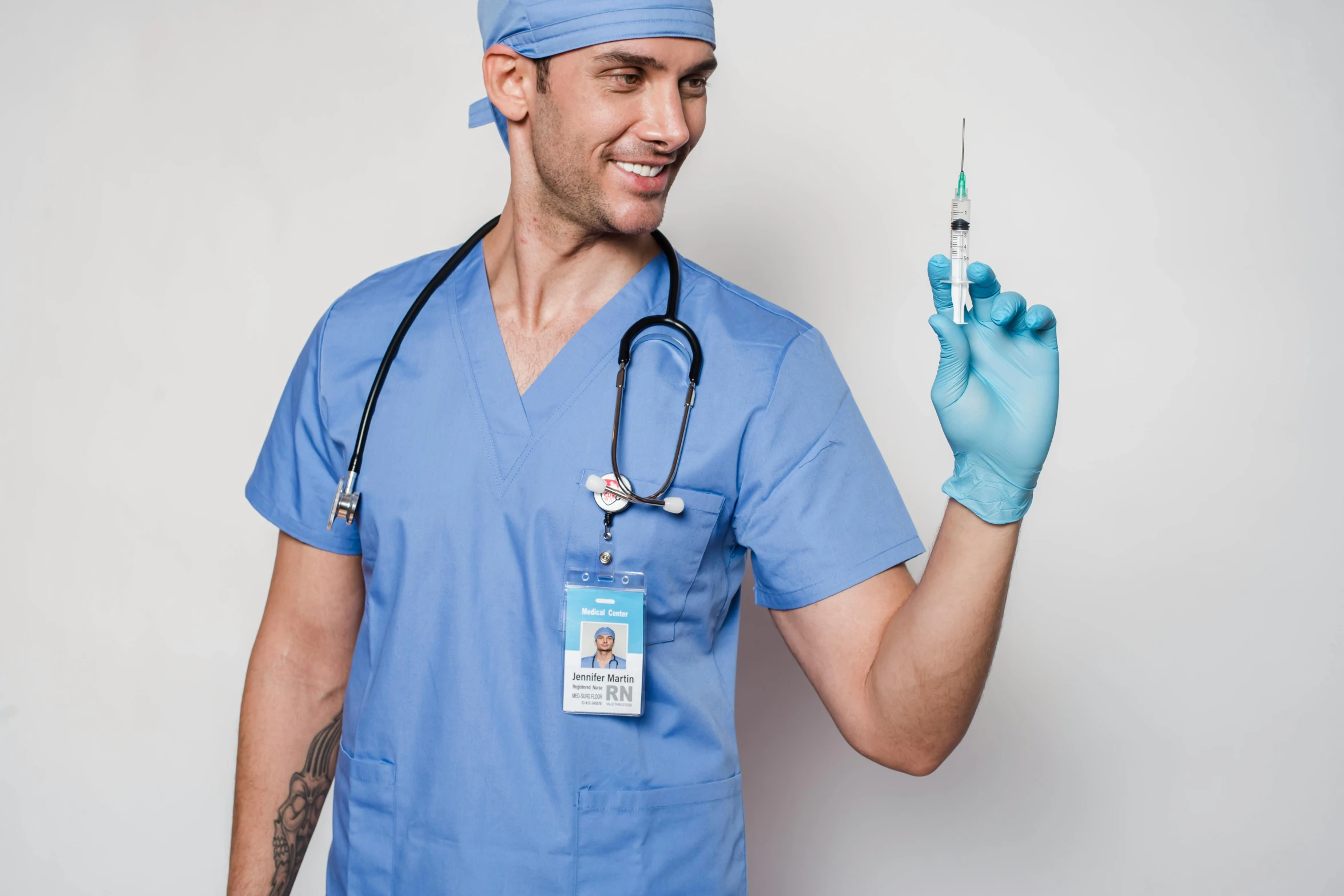a man in a blue scrub suit holding a syssor, by Kristian Zahrtmann, pexels contest winner, renaissance, syringe, steroid use, nurse costume, professional profile picture