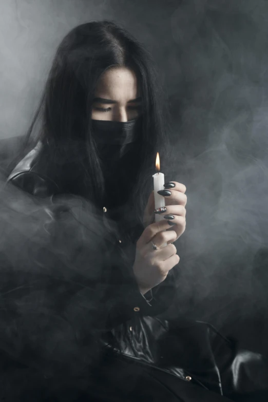 a woman sitting on a couch with a cigarette in her hand, an album cover, inspired by Carlo Mense, trending on pexels, romanticism, dark hooded wraith, handsome japanese demon boy, smoke grenade, candle wax
