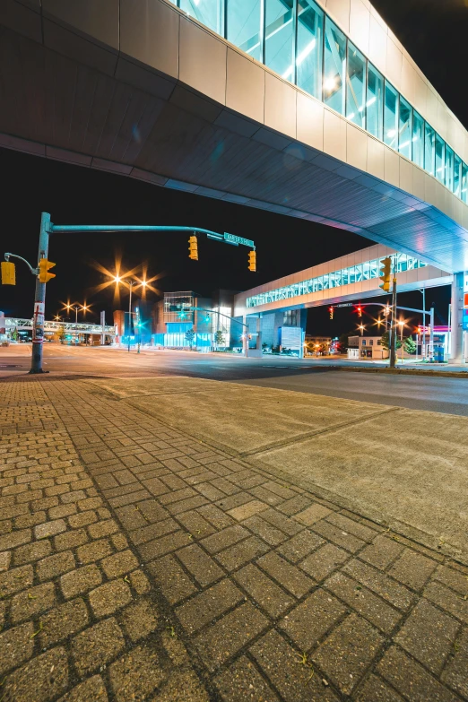 a red fire hydrant sitting on the side of a road, by Washington Allston, unsplash, neon lights above shops, overpass, street of teal stone, wide angle shot 4 k hdr