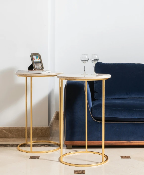 a living room filled with furniture and a blue couch, featured on pinterest, baroque, gold gilded circle halo, high resolution product photo, stone table, tall thin frame