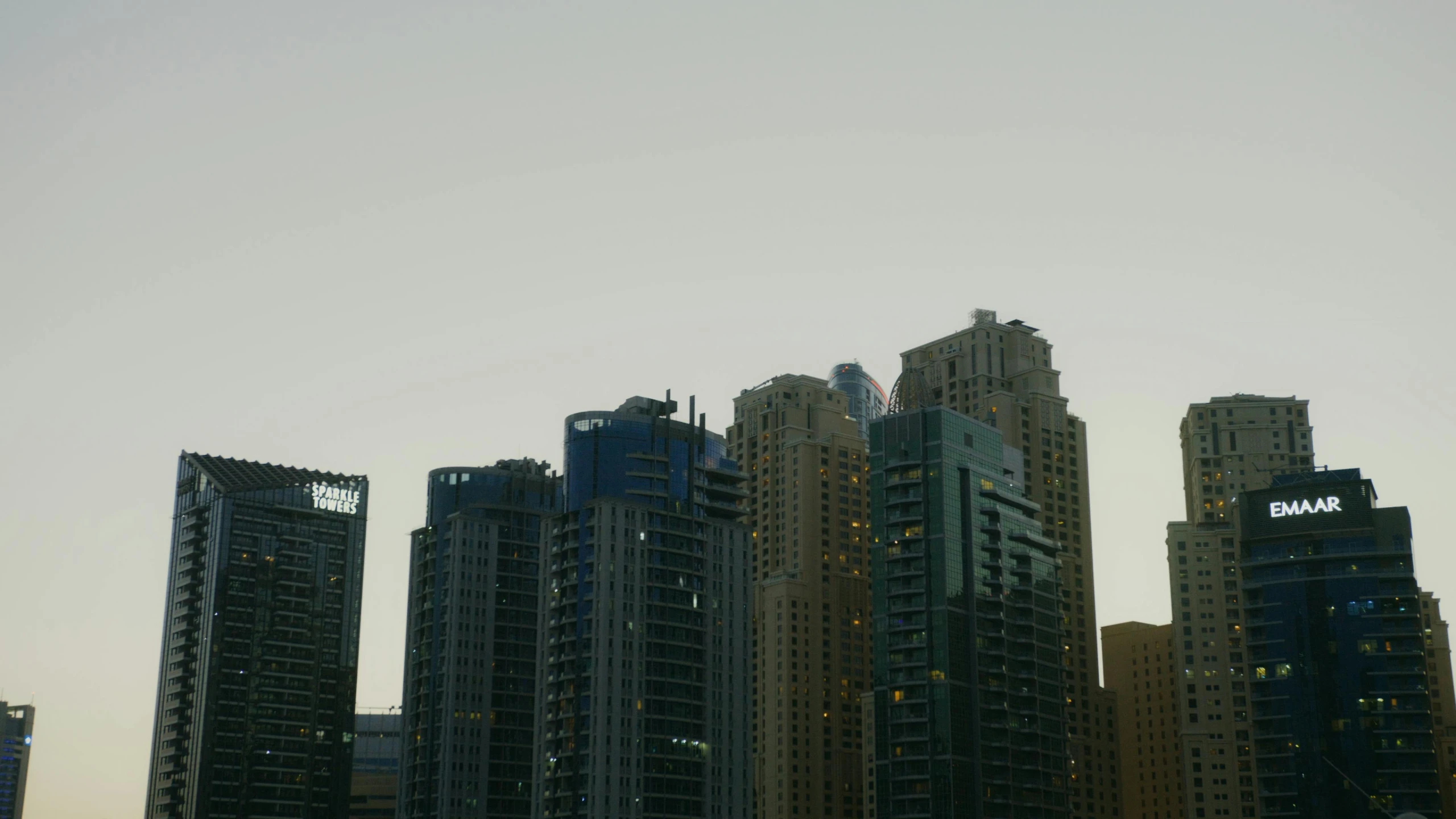 a group of tall buildings sitting next to each other, humid evening, gta : dubai, landscape photo